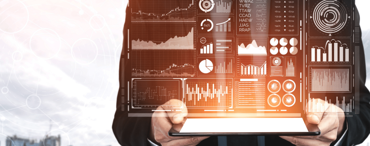 A man holding a tab sreening graphs of analytics
