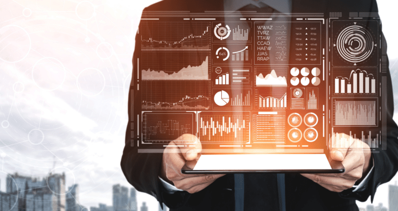 A man holding a tab sreening graphs of analytics